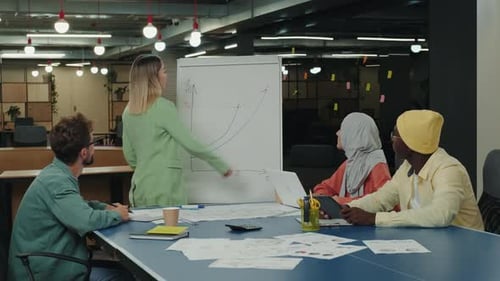 Colleagues Reviewing Financial Charts in Modern Office