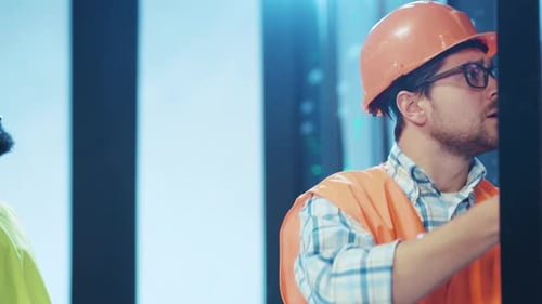 A Technician is Diligently Working with Specialized Tools Inside a Data Center Environment