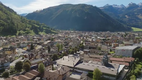 Aerial footage slowly rotating around the small downtown of a town in northern Italy during the day.