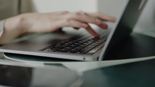 CloseUp of Hands Typing on Laptop in Office or Home Workspace