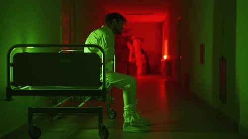 A Mad Male Patient in Straitjacket is Going Crazy in a Mental Hospital