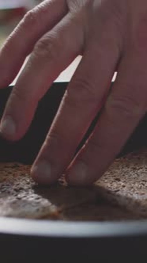 Close-up of Unrecognizable Hands Expertly Toasting Rye Bread