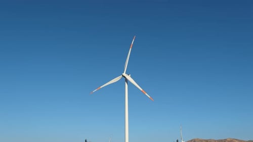 Wind Turbines Spinning Under Blue Sky