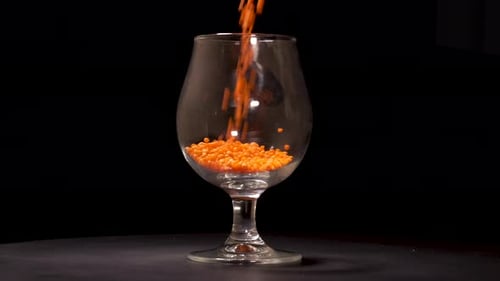 Orange Lentils Filling a Glass to Overflowing
