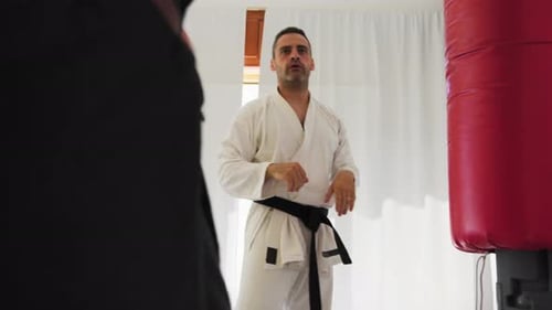 Adult Men Practicing Martial Arts in Bright Dojo