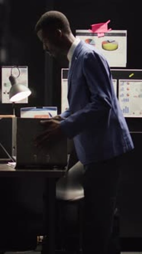 Man in Suit Analyzes Financial Data in Office