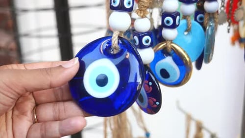Hand Holding an Evil Eye Amulet