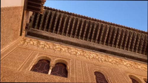 Tilt down shot of the facade of a Palace in the Alhambra of Granada.