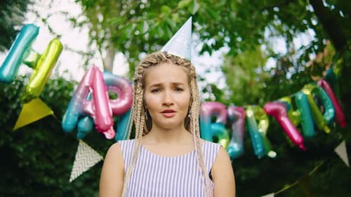 Woman at Birthday Party Looking Depressed