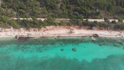 Aerial view of beautiful empty beach in Greece, no people. Dramatic coastline scenic bay rocky cliff