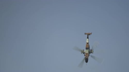 Military Helicopter Flying Through Cloudy Daytime Sky