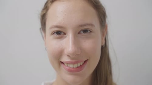 Close up of Caucasian woman open eyes looking and smile to camera