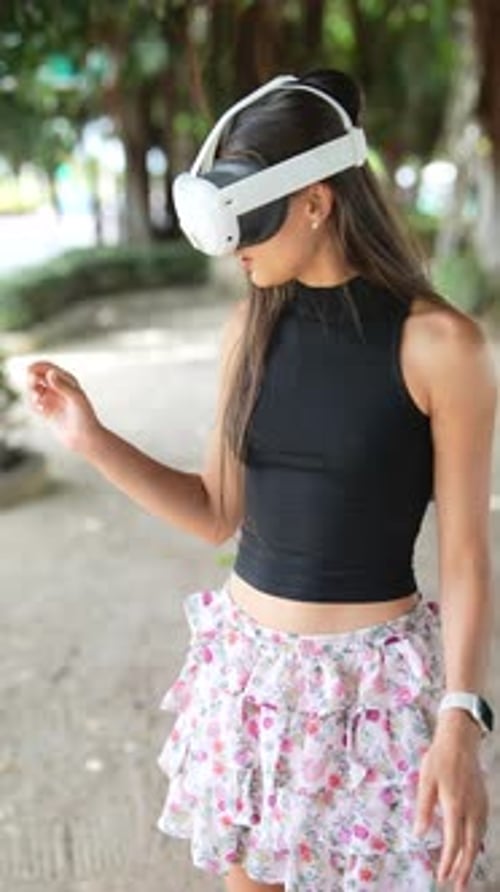 Young Woman with Stylish Virtual Reality Headset is Enjoying Immersive Experience in a Park Setting