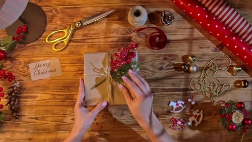 Adding Christmas Gift Tag to Brown Paper Package