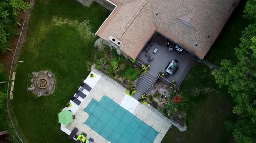 A winterized and covered pool shown in yard.,