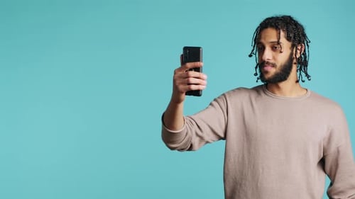 Man Video Chatting on Smart Phone