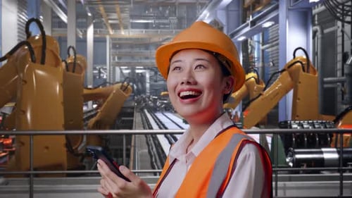 Close Up Side View Of Asian Female Engineer Using Smartphone With Robotic Arms