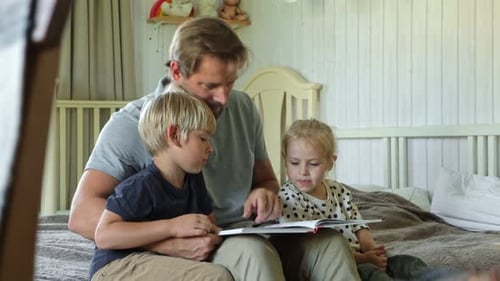 Father Reading Storybook to Children at Home