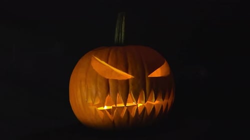 Glowing Jack-O'-Lantern with Candlelight on Halloween Night