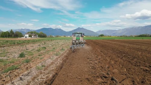 Tractor Tilling the Soil in Rural Farmland