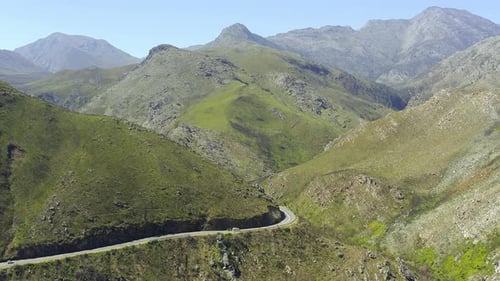 4k video of a car driving on a road through a mountainous countryside region