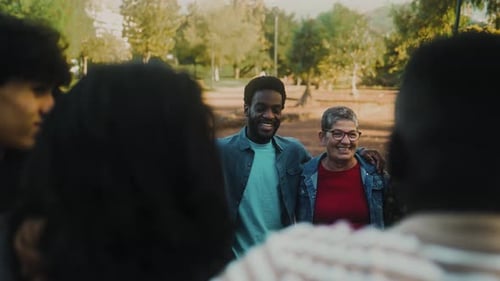 Happy multigenerational group of people with different ethnicities having fun in a public park