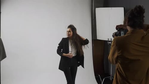 Model and Production Team in the Studio Woman in Suit Posing for Photographer Smiling Having Fun