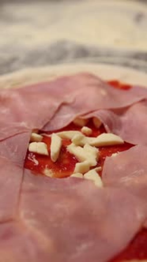 The chef makes delicious pizza in a professional kitchen.