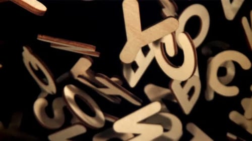 Floating Wooden Letters Against a Black Backdrop