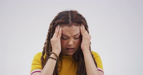 Woman with Dark Hair Massaging Temples