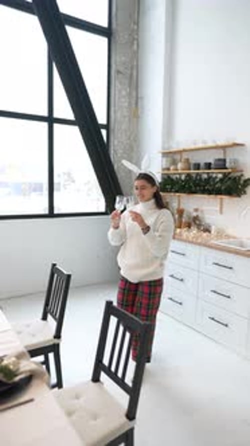 Young Woman Setting New Year's Table at Living Room