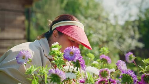 A Flower Enthusiast Engages with Vibrant Blooms Immersed in Nature's Beauty While Carefully Tending