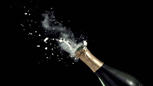 Slow motion champagne bottle pops open for new year celebration