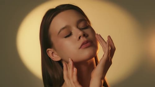 Close Up Beauty Portrait of Young Woman with Soft Spotlight on Background