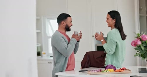 Couple Laughs Together in Bright Kitchen