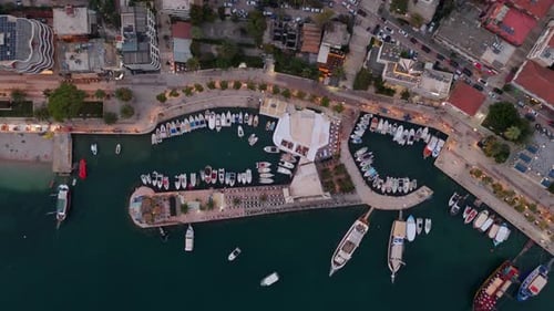 Saranda's marina in albania with boats and yachts at sunset, captured by a drone, aerial view