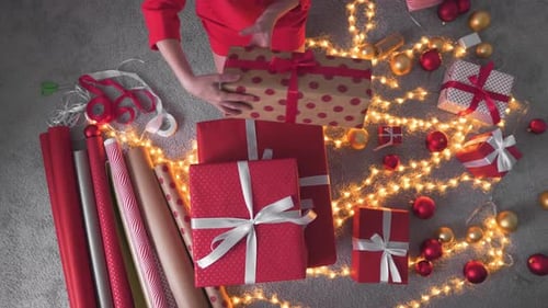Woman Arranging Christmas Gifts from Overhead