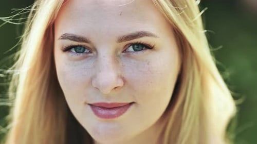 Blonde Woman Smiling in a Close Up Portrait
