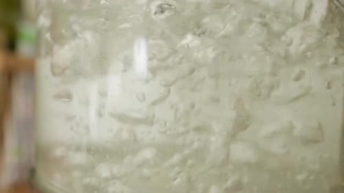 Boiling Water Churns in Clear Glass Container