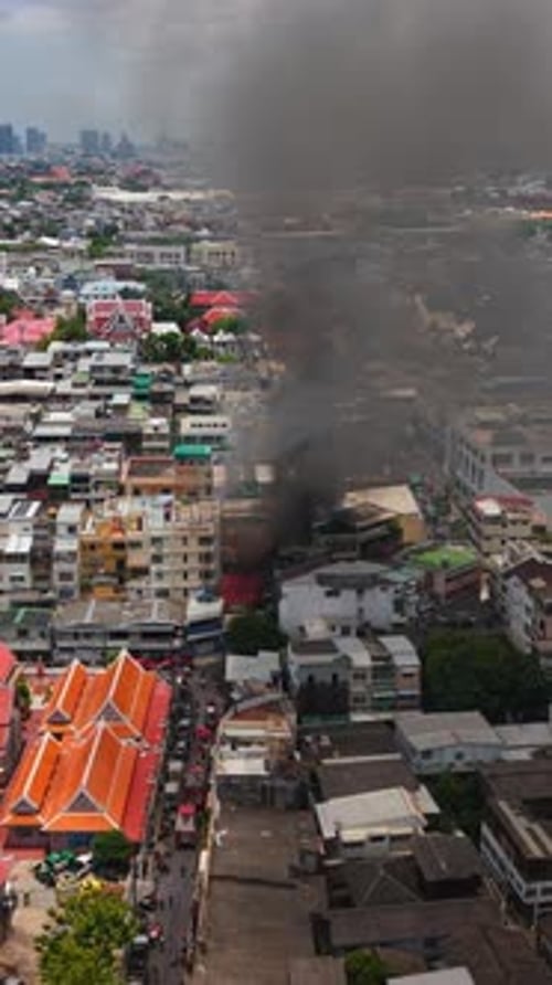 Dark Thick Smoke Rising From a Burning Urban Building Rising Above the Bangkok Skyline During the