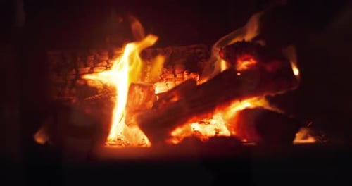 Fireplace, wood and home with flame at night for Christmas holiday, festive and winter