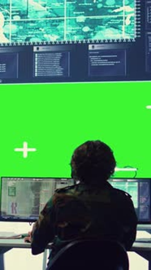 Figure at Computer with Green Screen and Data