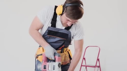 Man Working With Power Tool Indoors