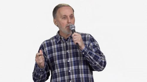 Man Speaking Into Microphone and Singing