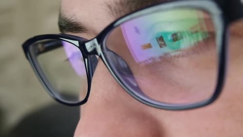 Close Up of Tired Man Working at Night on Laptop Man in Eye Glasses with Reflections Overworking