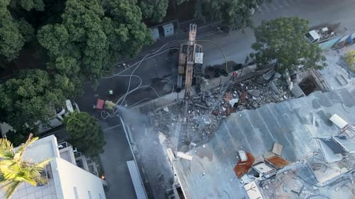 Site de démolition avec excavatrice retirant la structure du toit