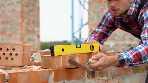 Worker Control Brick Wall Using Level Tool