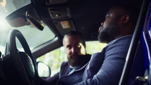 Men Talk in Car at Dealership