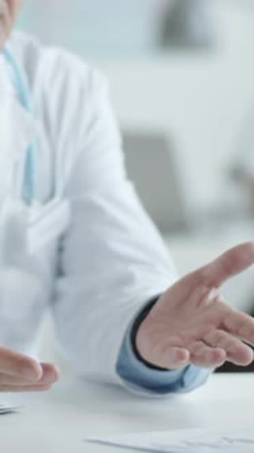 Doctor Giving Handshake and Talking to Patient on Consultation