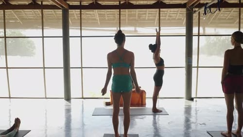Yoga Teacher Performs Different Poses in Front of the Class